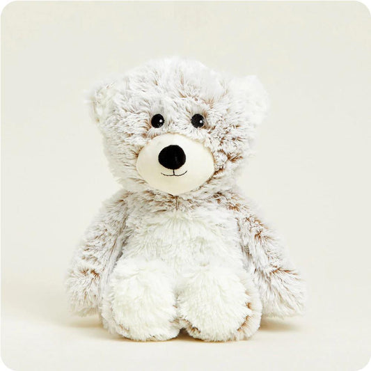 Fluffy teddy bear with a cute face sitting upright.