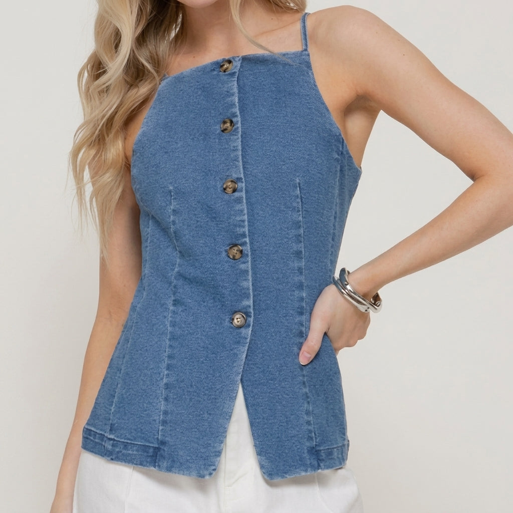 Woman in a blue button-up denim top with white pants.