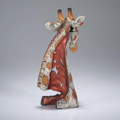 Abstract giraffe sculpture on a smooth gray background.