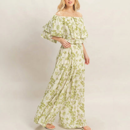 Woman in floral off-shoulder dress with soft, flowing tiers.
