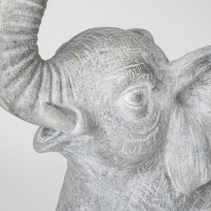 Close-up of a textured stone elephant sculpture head.