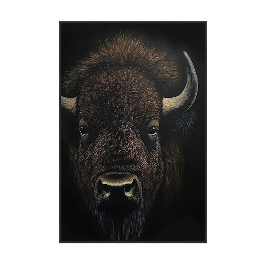 Close-up of a bison against a dark background, showcasing its horns and fur.