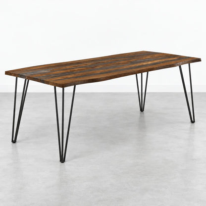 Wooden table with metal hairpin legs on a gray floor.