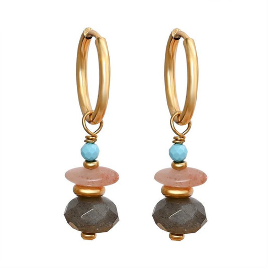 Gold hoop earrings with colorful stone accents.