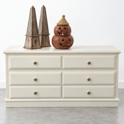 Cream dresser with Halloween decorations on top.