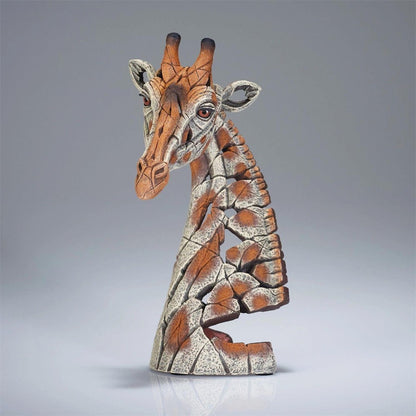 Clay giraffe sculpture with a cracked texture, on a gray background.