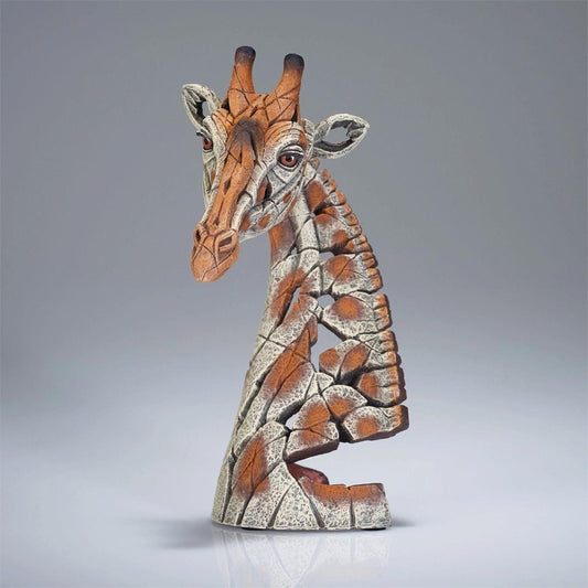 Clay giraffe sculpture with a cracked texture, on a gray background.