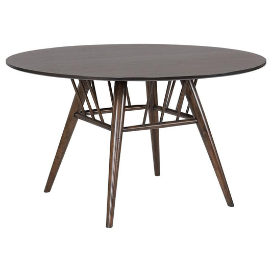 Round wooden table with geometric leg design.