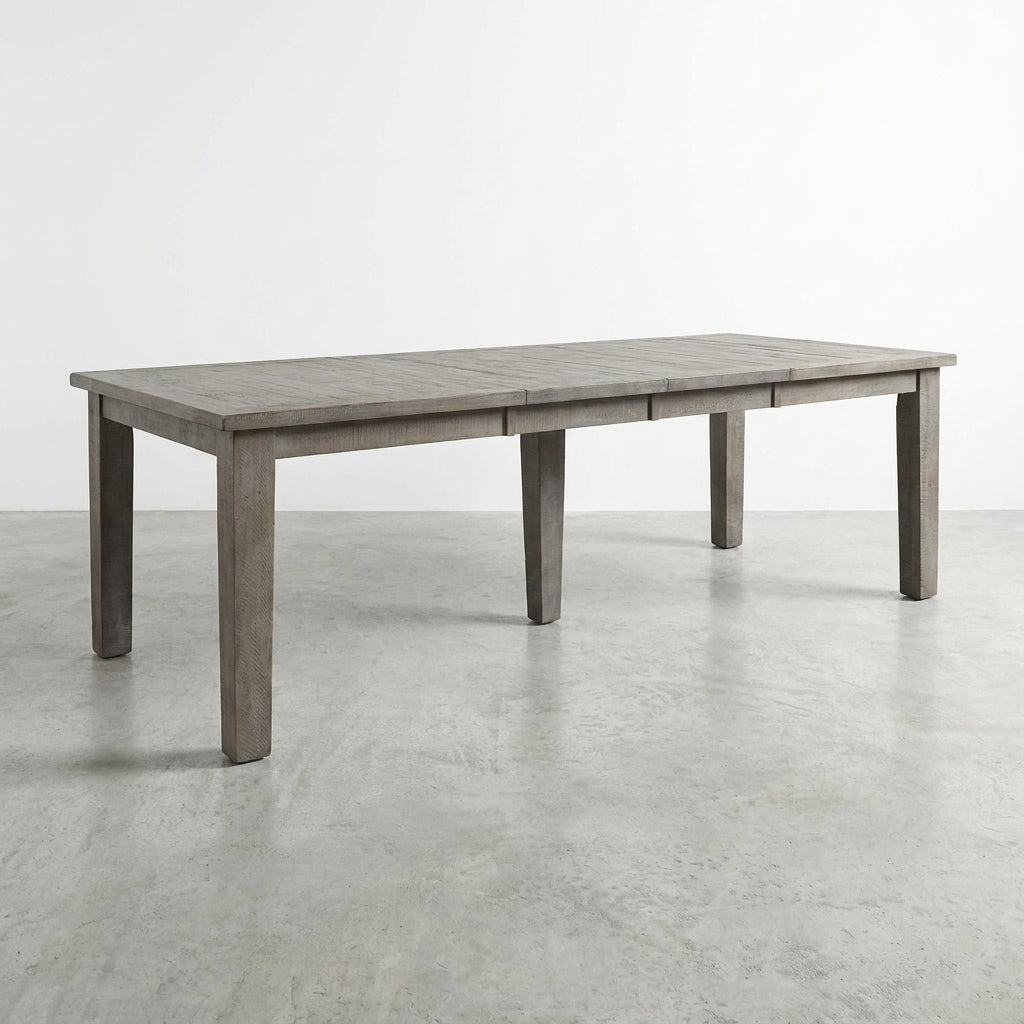 Long wooden dining table on a white background.