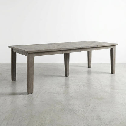 Long wooden dining table on a white background.