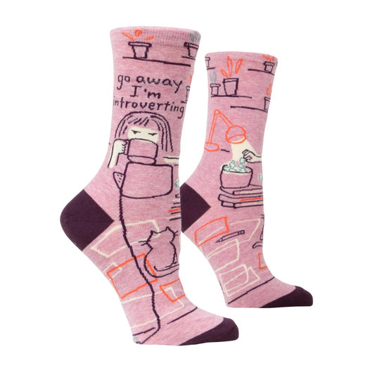 Pink socks featuring an introvert theme with books, a cup, and plants.