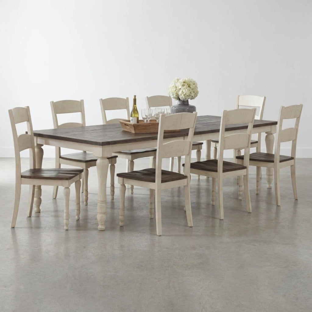 Rustic dining table with eight chairs and floral centerpiece.