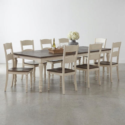 Rustic dining table with eight chairs and floral centerpiece.