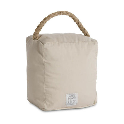 Beige fabric doorstop with rope handle.