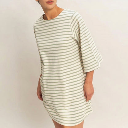 Person wearing a striped, knee-length dress against a plain background.
