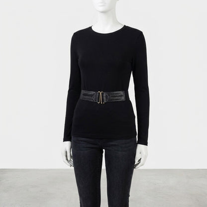 Mannequin in black outfit with wide belt, minimalist background.