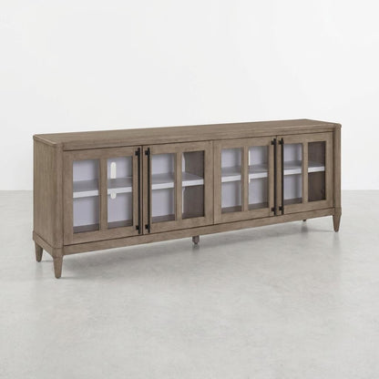 Wooden sideboard with glass doors and black handles.