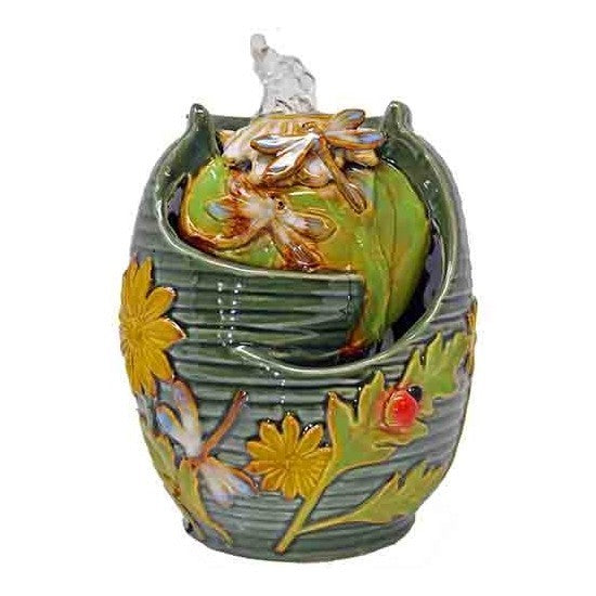 A decorative green vase with floral accents and intricate details.