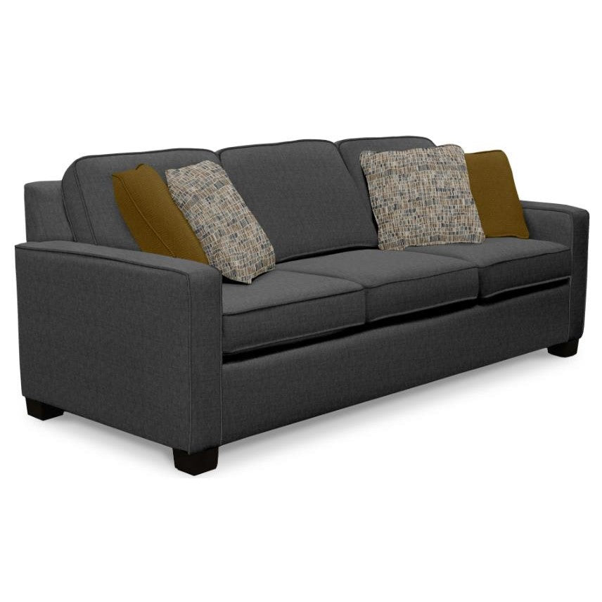 Gray sofa with patterned and solid cushions.