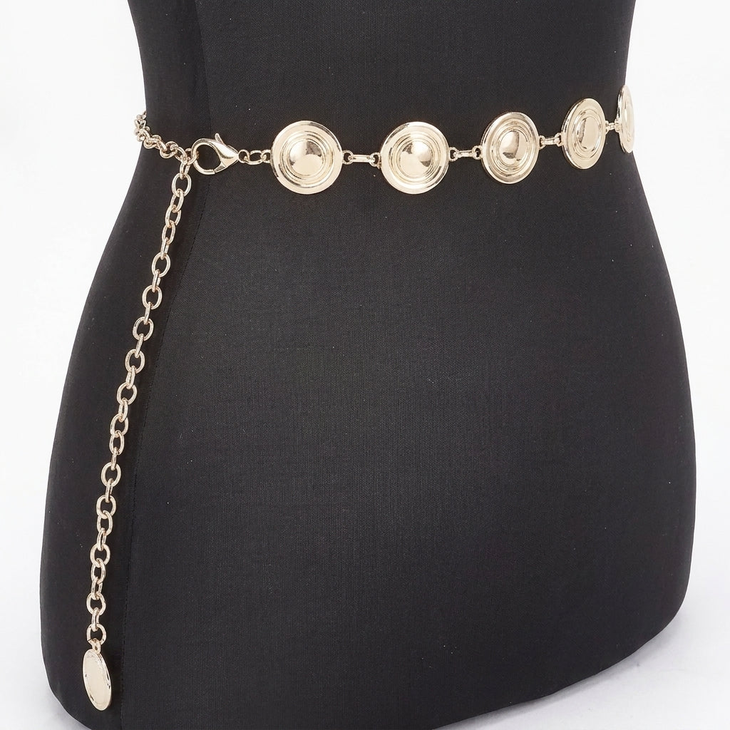 Gold chain belt with round discs displayed on a black mannequin.