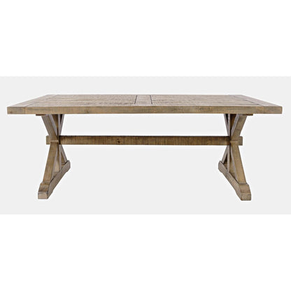 Rustic wooden dining table with trestle legs.