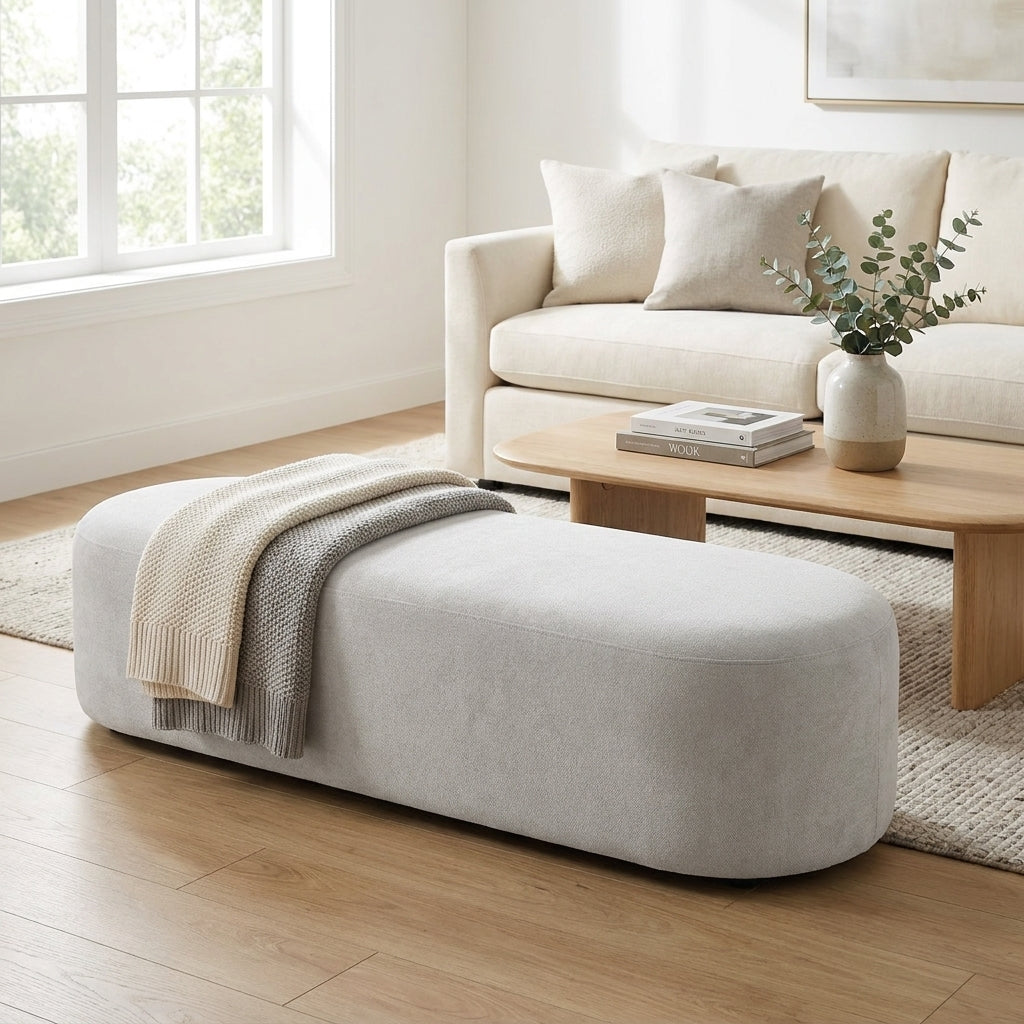Minimalist gray bench with a smooth, rounded design.