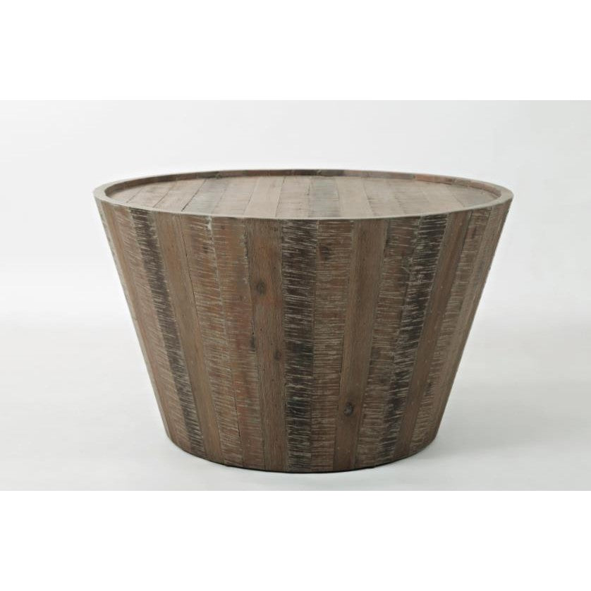 Round wooden coffee table with a rustic finish.