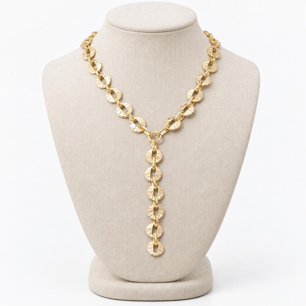 Gold chain necklace on a display bust.
