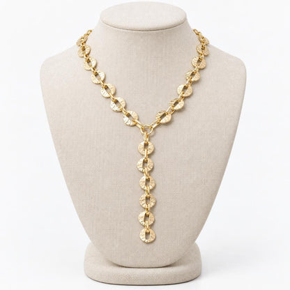 Gold chain necklace on a display bust.