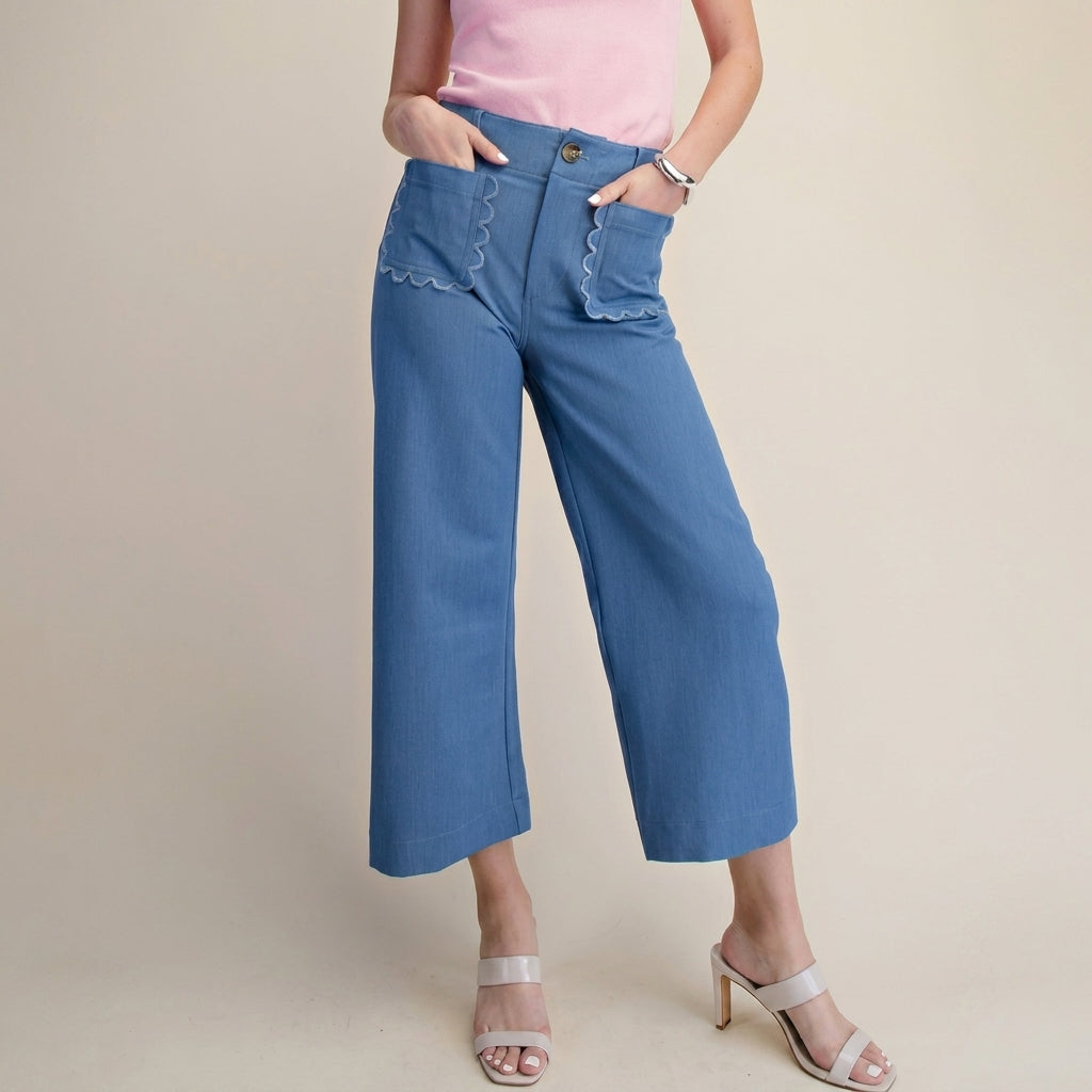 Pink top, blue pants with scalloped pockets, white heels.