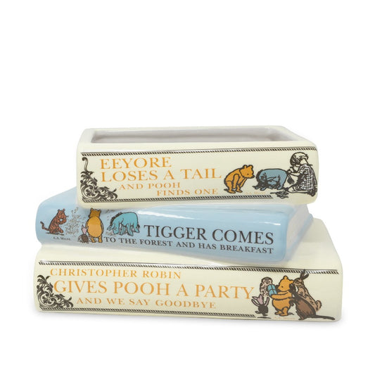 Decorative book-themed dishware with Winnie the Pooh designs.