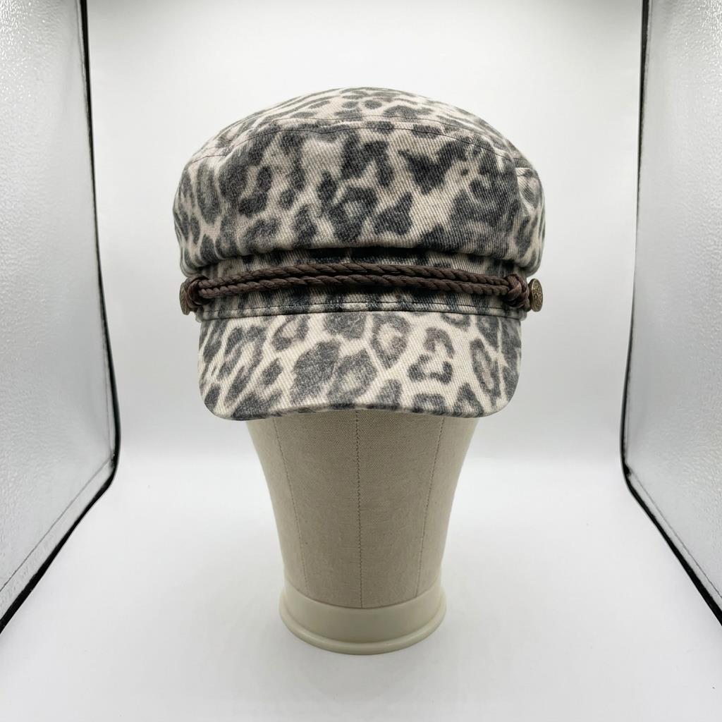 Leopard print cap with braided band displayed on a mannequin.