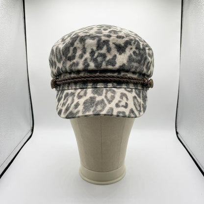 Leopard print cap with braided band displayed on a mannequin.