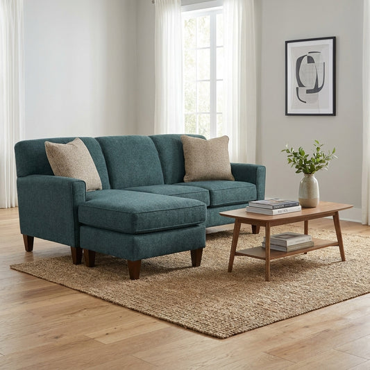 Cozy living room with a teal sofa, wooden table, and minimalist decor.