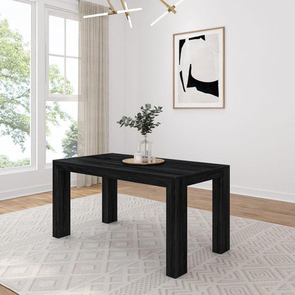 Minimalist dining room with black table and abstract art.
