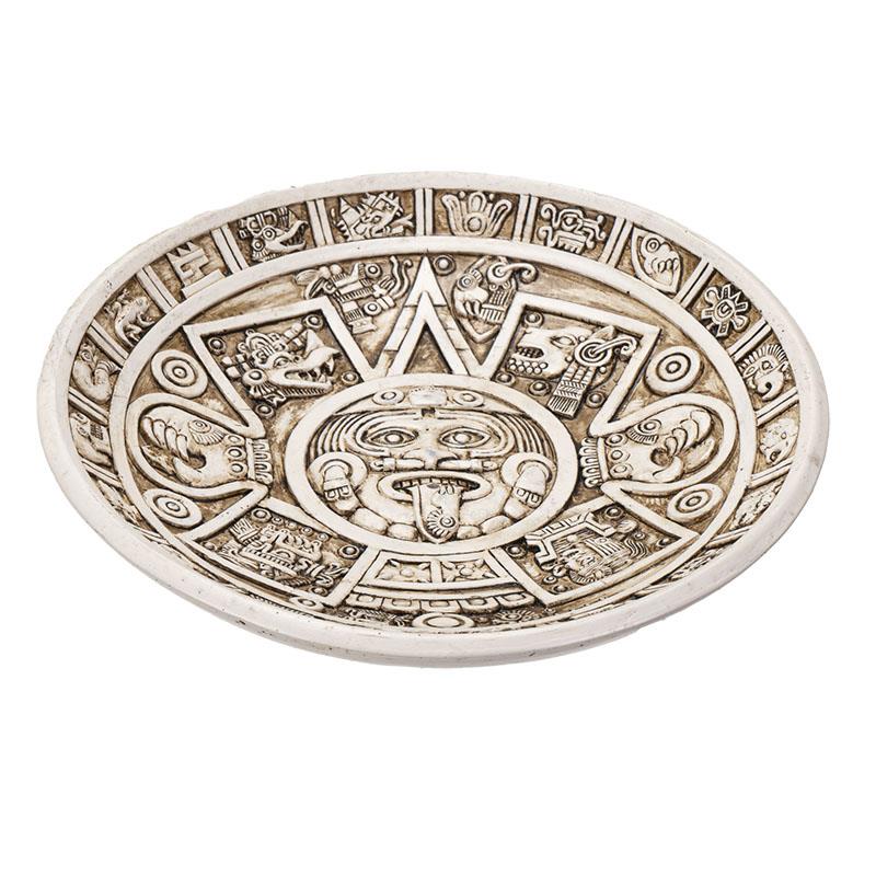 Intricate Mayan-style circular plate with detailed carvings.