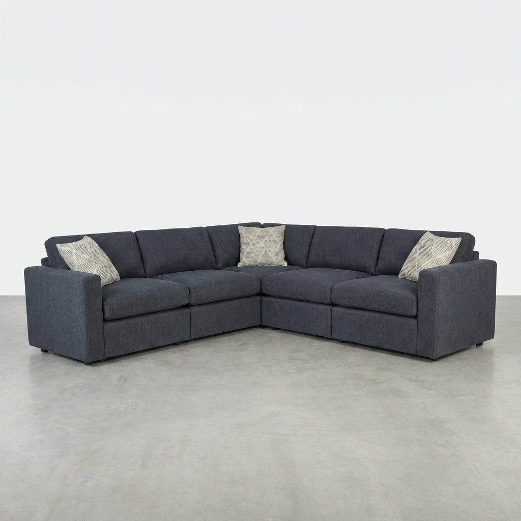 Dark gray L-shaped sectional sofa with three cushions.