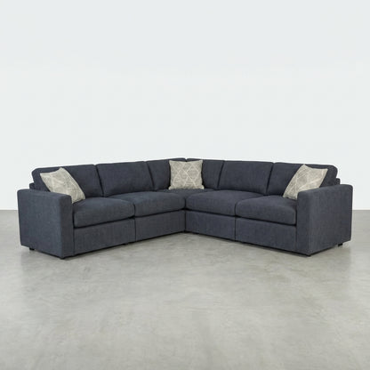 Dark gray L-shaped sectional sofa with three cushions.