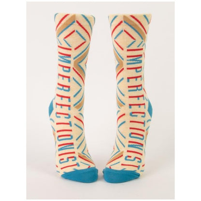 Cream socks with colorful lines reading "IMPERFECTIONIST."