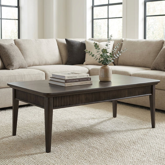 Dark wooden rectangular coffee table with tapered legs.