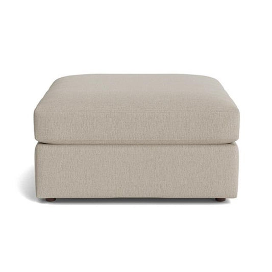 Beige square ottoman with simple, modern design.