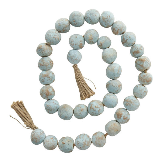 Beaded garland with light blue rustic beads and tassels.