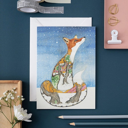 Colorful fox illustration with stationery on a blue background.