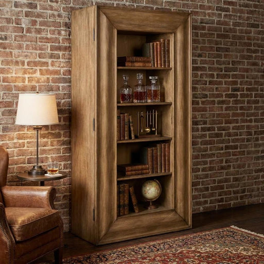 A cozy study features a wooden bookcase, vintage books, crystal decanters, and a leather chair.