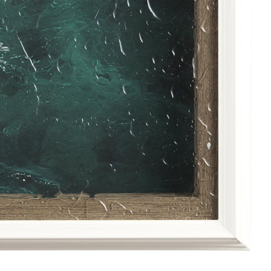 Framed artwork with raindrops on glass cover.
