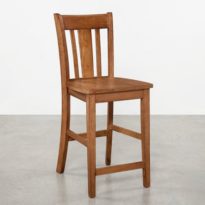 Wooden chair with slatted back on a grey floor.