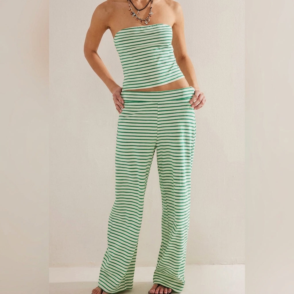 Model in green striped tube top and pants against a plain backdrop.