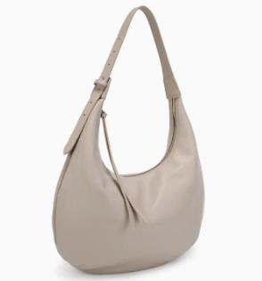 Beige shoulder bag with adjustable strap.