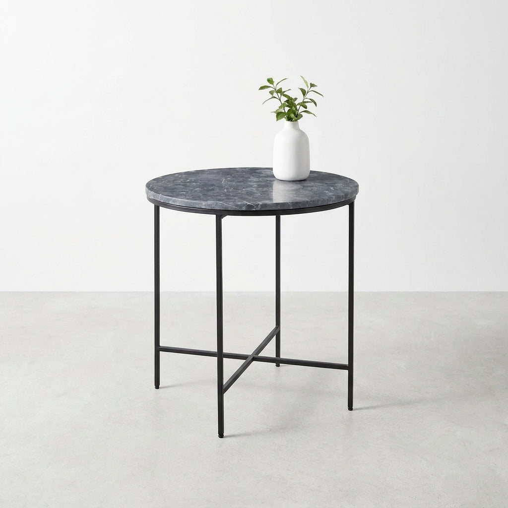 Round table with marble top, potted plant on it.