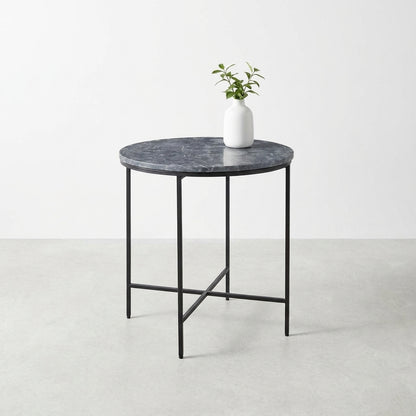 Round table with marble top, potted plant on it.